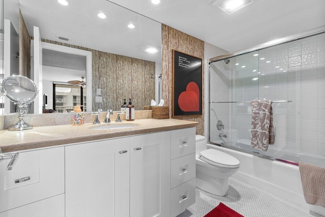 full bathroom with vanity, toilet, tile patterned floors, and enclosed tub / shower combo