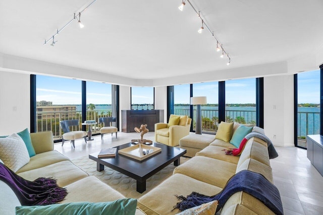 living room with a water view and rail lighting