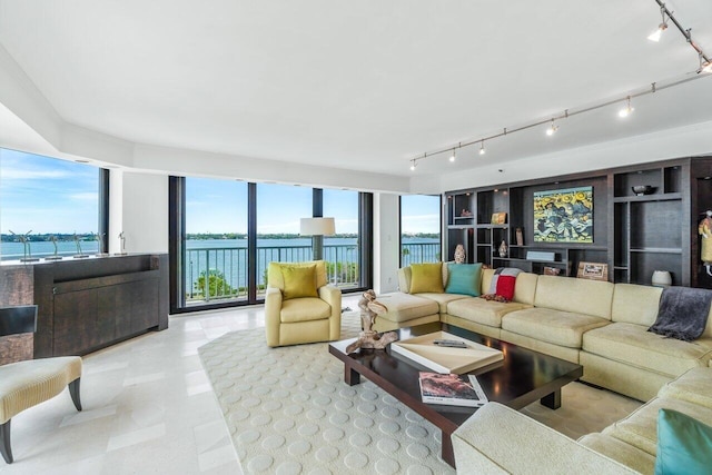 living room featuring track lighting and a water view