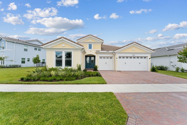 view of front of home featuring a garage and a front lawn