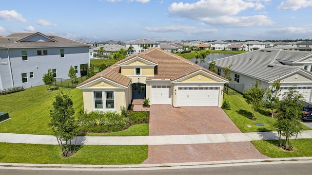 view of front of property with a garage and a front yard