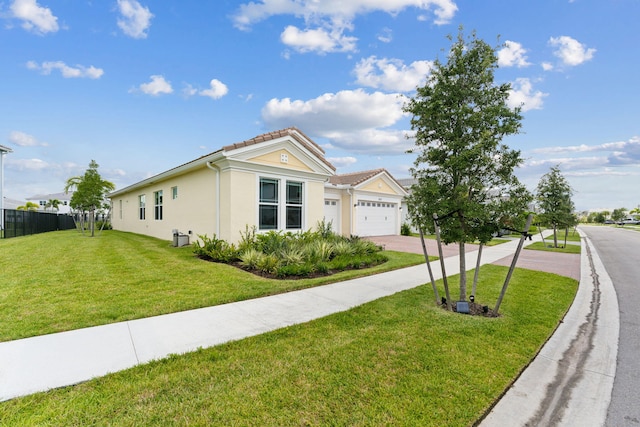 view of front of property with a garage and a front yard