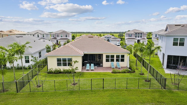 rear view of house featuring a yard and a patio area