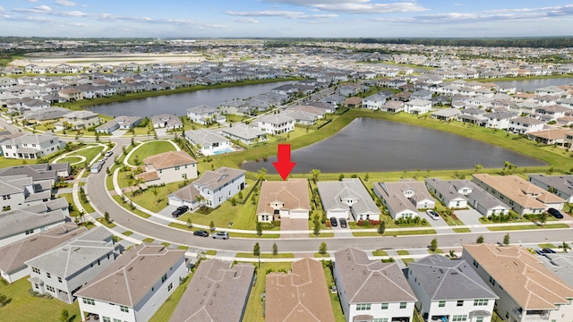 birds eye view of property with a water view