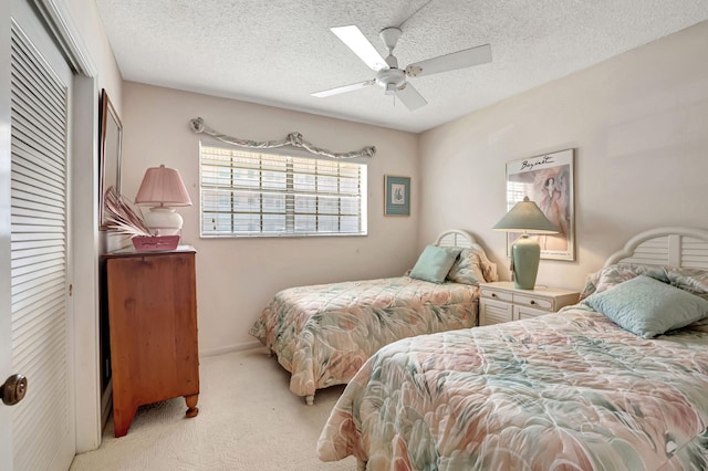 bedroom with light carpet, a closet, a textured ceiling, and ceiling fan