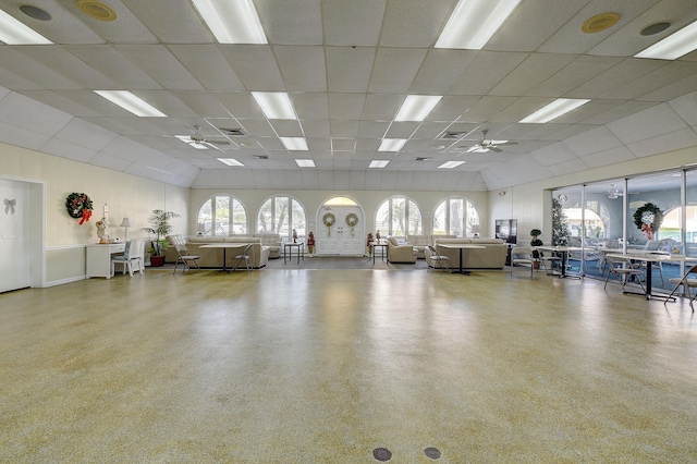 workout area with a paneled ceiling and a healthy amount of sunlight