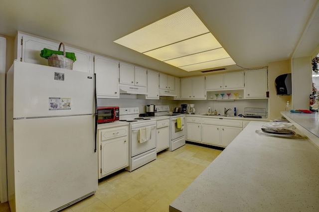 kitchen with white cabinets, sink, and white appliances