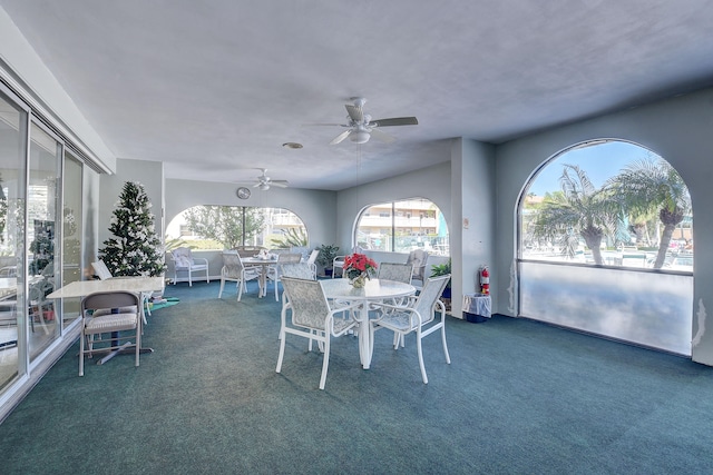 dining room featuring dark carpet and ceiling fan