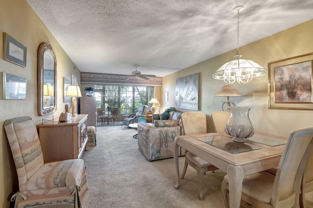 interior space with light carpet, a textured ceiling, and ceiling fan with notable chandelier