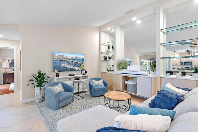 living room featuring light tile patterned flooring and a textured ceiling