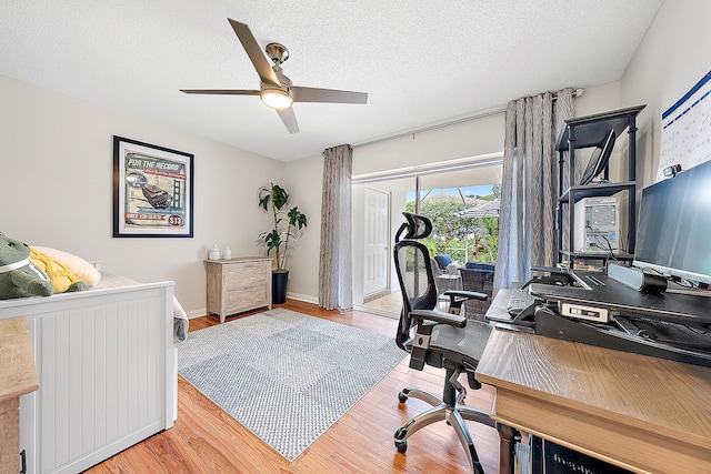 office space with ceiling fan, hardwood / wood-style floors, and a textured ceiling