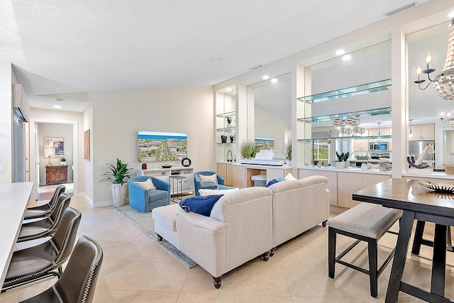 tiled living room featuring plenty of natural light, sink, built in features, and a textured ceiling