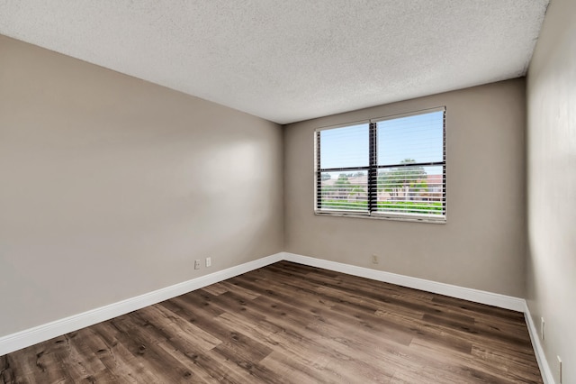 unfurnished room featuring a textured ceiling and wood-type flooring