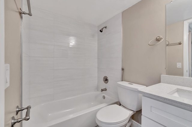 full bathroom featuring toilet, tiled shower / bath, and vanity