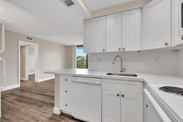 kitchen featuring backsplash, white cabinetry, dark wood-type flooring, sink, and white appliances