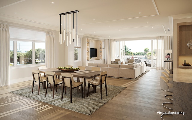 dining area with crown molding and light hardwood / wood-style floors