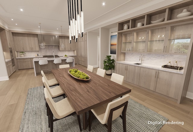 dining space with sink, crown molding, and light hardwood / wood-style floors