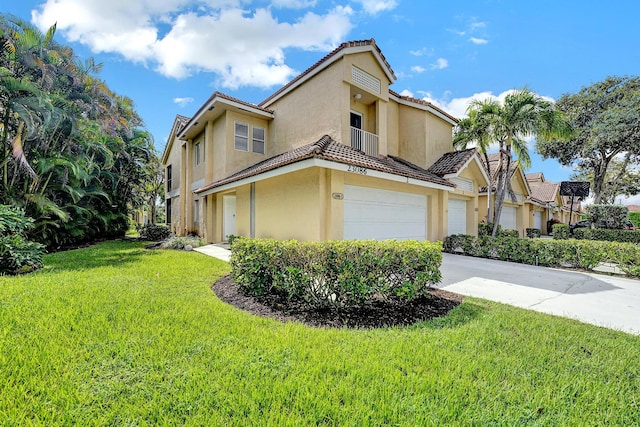 view of front of house with a front yard and a garage