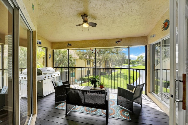 sunroom / solarium with ceiling fan and vaulted ceiling