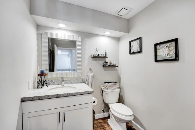 bathroom featuring hardwood / wood-style flooring, vanity, and toilet