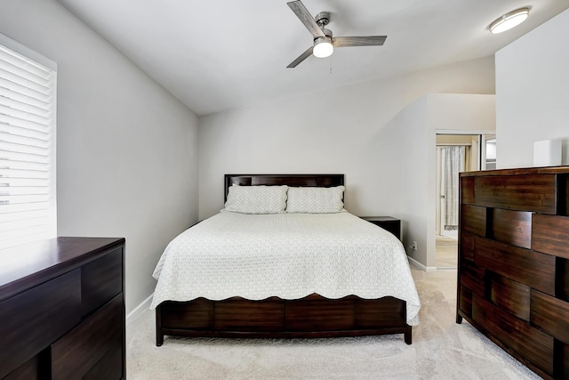 carpeted bedroom featuring vaulted ceiling and ceiling fan