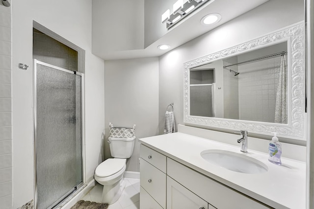 bathroom with vanity, toilet, and a shower with door