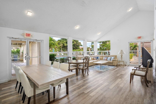 dining space with hardwood / wood-style floors, french doors, and a wealth of natural light