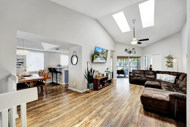 living room with wood-type flooring, ceiling fan, and high vaulted ceiling