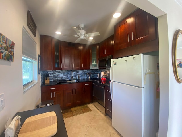 kitchen with sink, stainless steel appliances, backsplash, light tile patterned floors, and ceiling fan