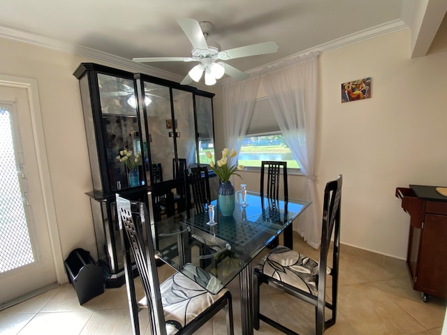 dining room with ceiling fan, light tile patterned flooring, and ornamental molding