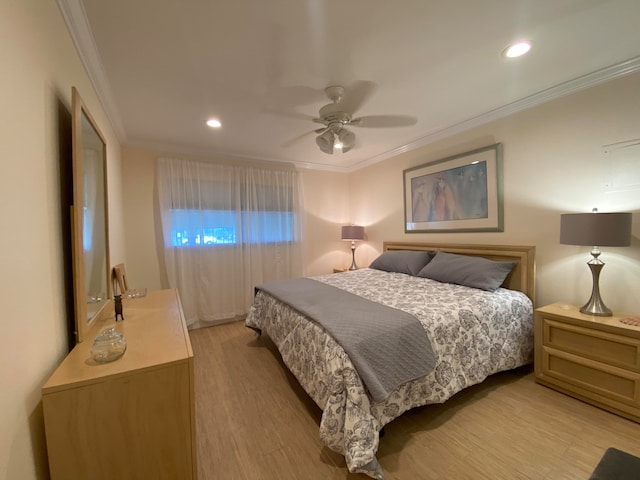 bedroom featuring crown molding, ceiling fan, and light hardwood / wood-style flooring