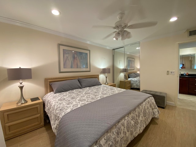 bedroom with ceiling fan, ornamental molding, a closet, and light hardwood / wood-style floors