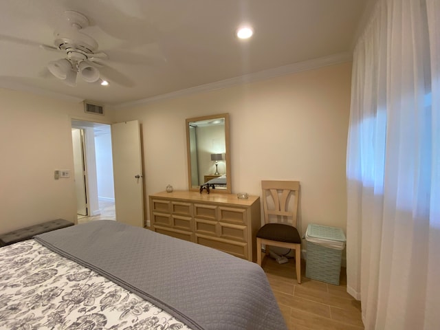 bedroom featuring ornamental molding, ceiling fan, and light hardwood / wood-style flooring