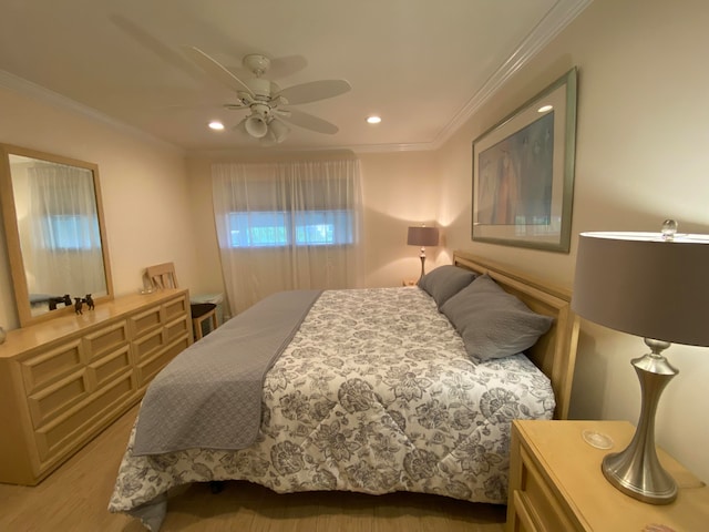 bedroom featuring crown molding, ceiling fan, and light hardwood / wood-style flooring