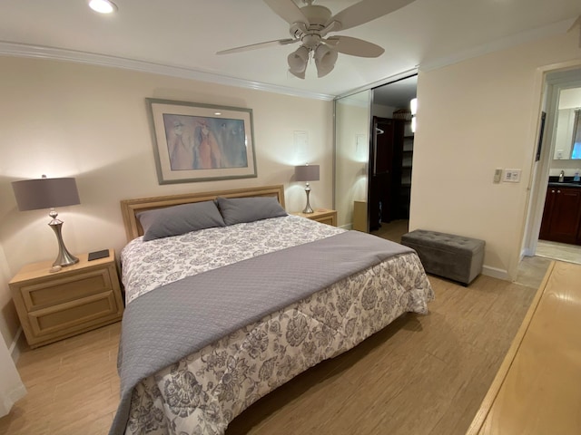 bedroom with ceiling fan, a closet, connected bathroom, and ornamental molding