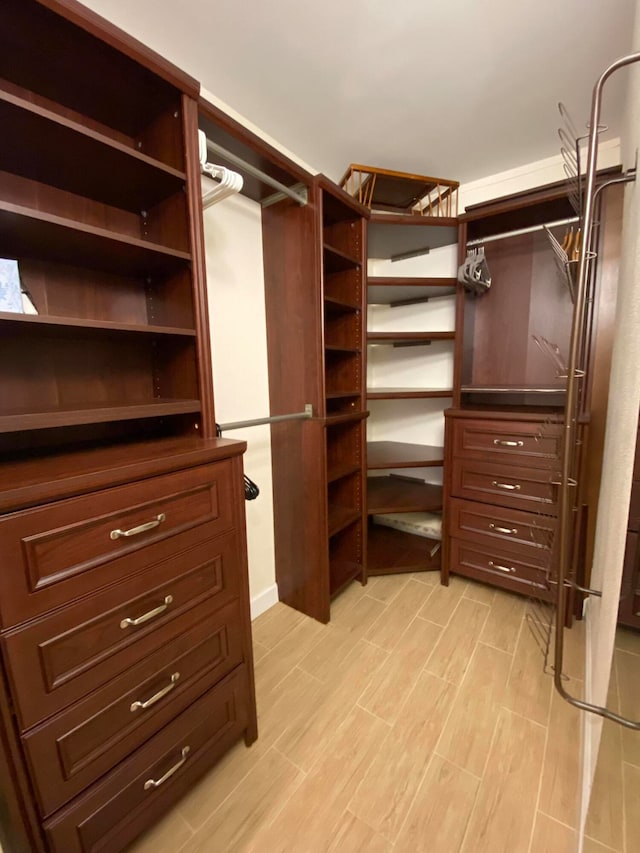 spacious closet featuring light hardwood / wood-style floors