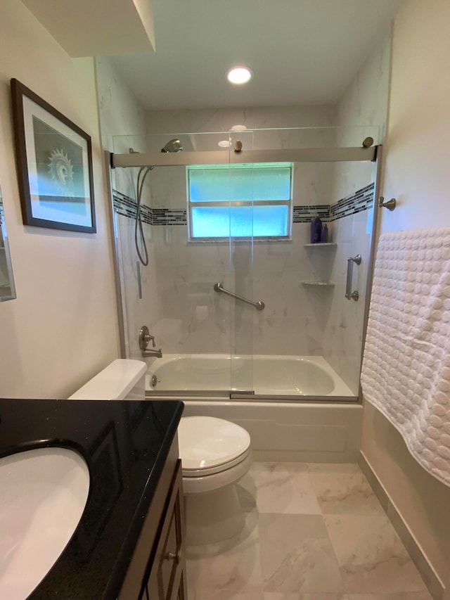 full bathroom with bath / shower combo with glass door, vanity, and toilet