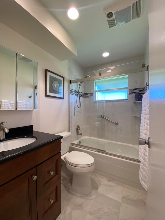 full bathroom featuring combined bath / shower with glass door, vanity, and toilet