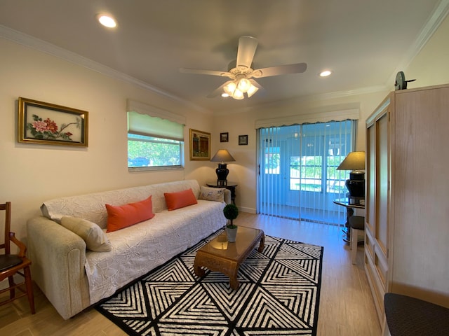 living room featuring light hardwood / wood-style flooring, ceiling fan, and ornamental molding