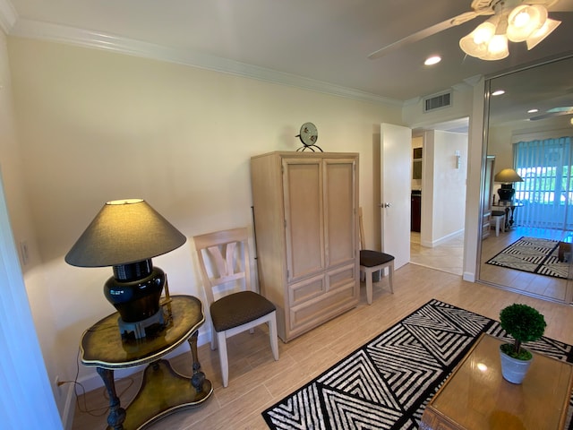 interior space featuring light hardwood / wood-style flooring, ceiling fan, and ornamental molding