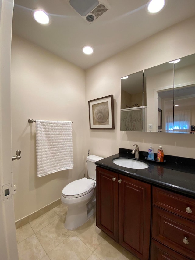 bathroom with tile patterned flooring, a shower with door, vanity, and toilet