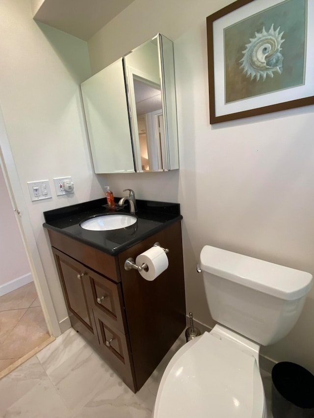 bathroom featuring vanity and toilet