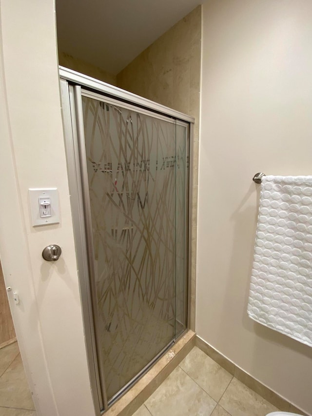 bathroom with tile patterned flooring and an enclosed shower