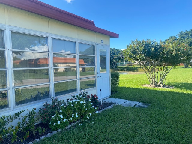 view of property exterior with a lawn