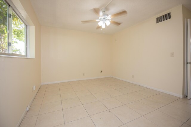 unfurnished bedroom with a closet, ceiling fan, and light tile patterned floors