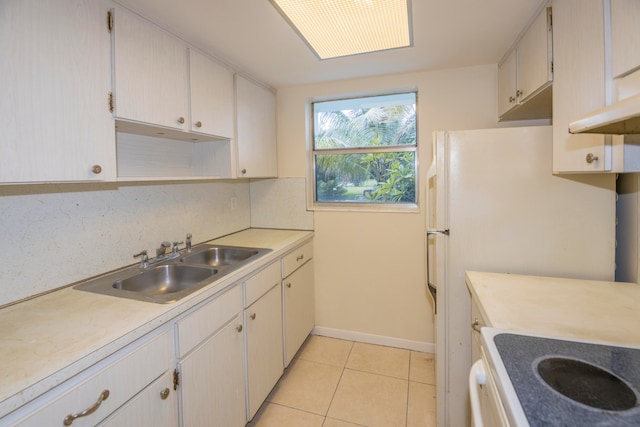 kitchen with backsplash, stove, sink, and light tile patterned floors