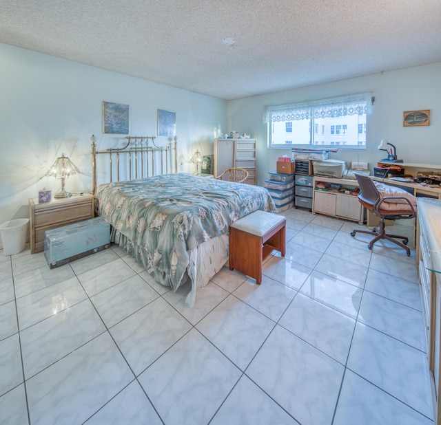 tiled bedroom featuring a textured ceiling