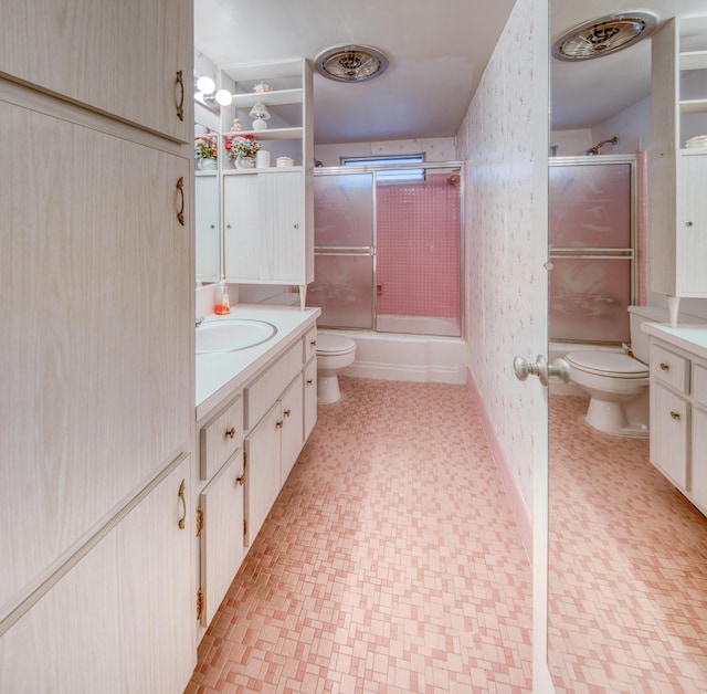 full bathroom with shower / bath combination with glass door, vanity, and toilet