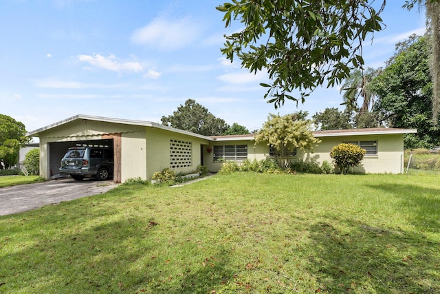 ranch-style house featuring a front yard and a garage