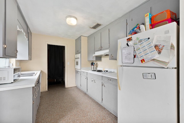 kitchen featuring gray cabinetry, sink, and white appliances